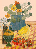 Bananas, tomatoes and a vase of flowers on a checked tablecloth