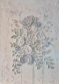 A cluster of roses sculpted in white relief on pale grey