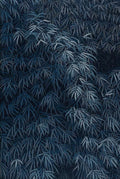 Dense bamboo leaves in silvery blue on dark navy
