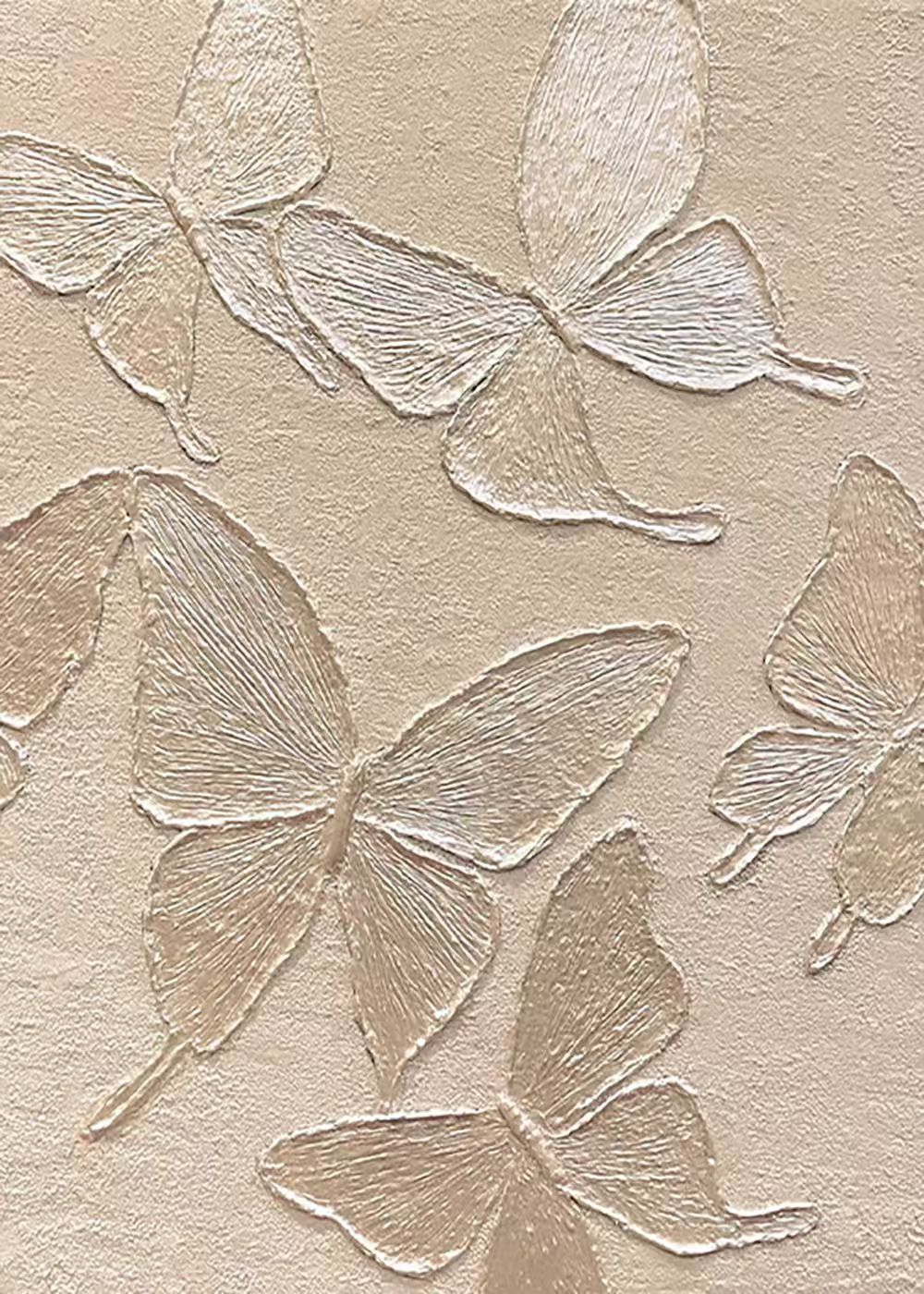 Large butterflies sculpted in ivory relief on warm beige