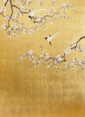 Two long-tailed white birds among pale pink blossom branches on a burnished gold ground