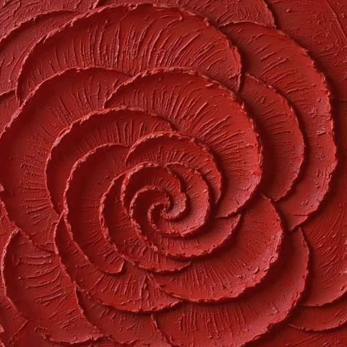 A huge spiralling rose carved in deep crimson paint