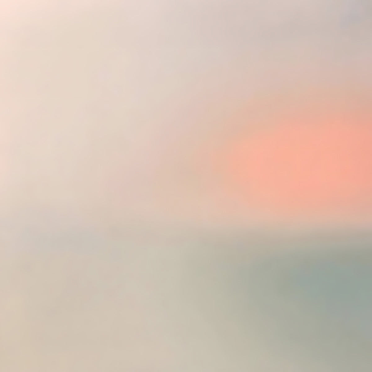 A soft coral sun glowing through a pale haze of grey and mint