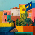 Bright stacked houses in yellow, pink, blue and red with palms and agaves along a waterfront