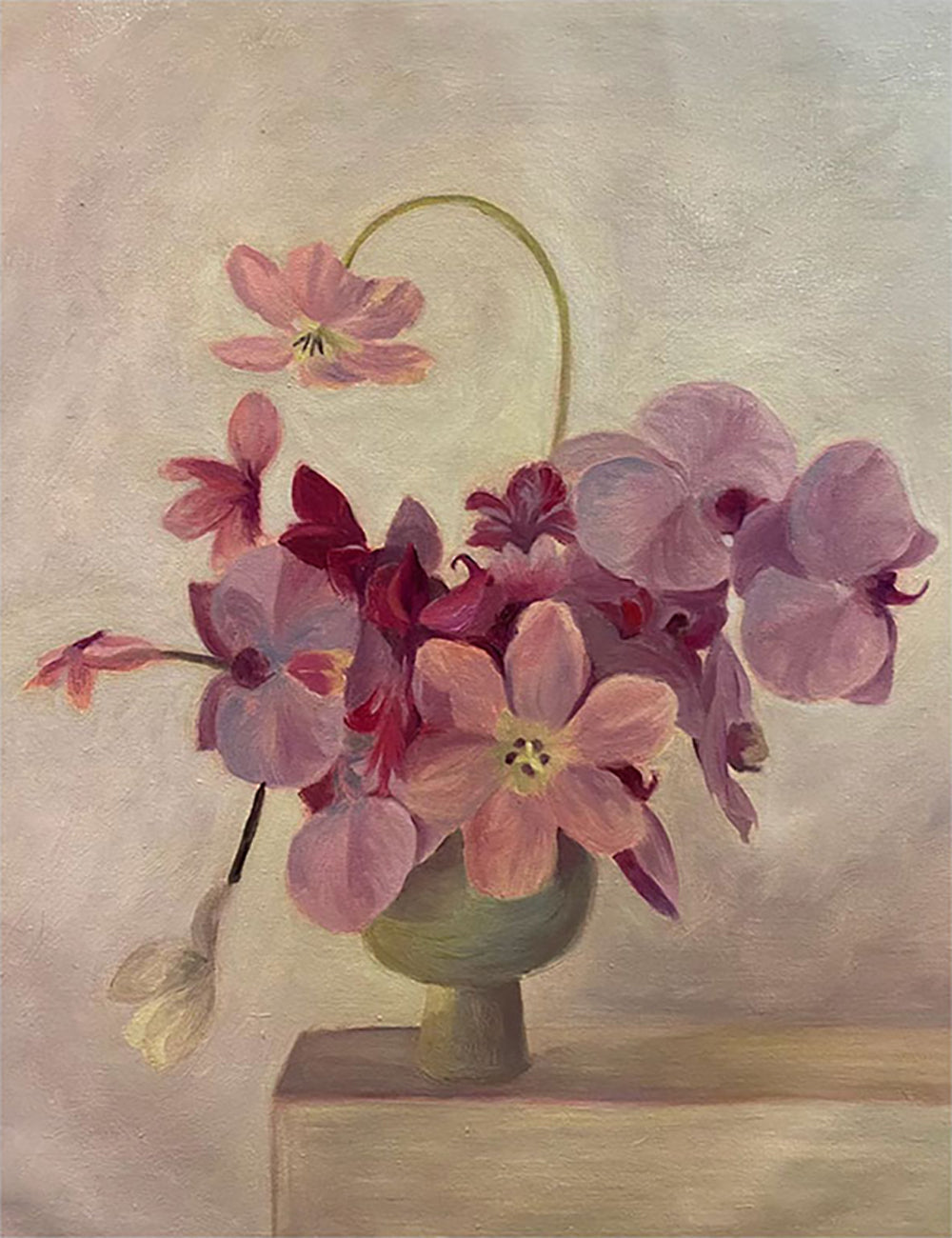 Pink, plum and mauve orchids spilling from a small green pot on a pale ledge