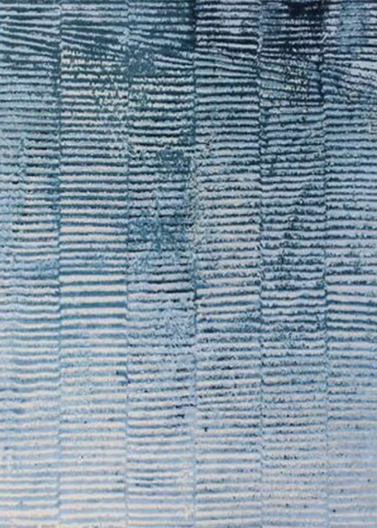 Rows of fine wave-like ridges in denim, sky and white, like windblown water