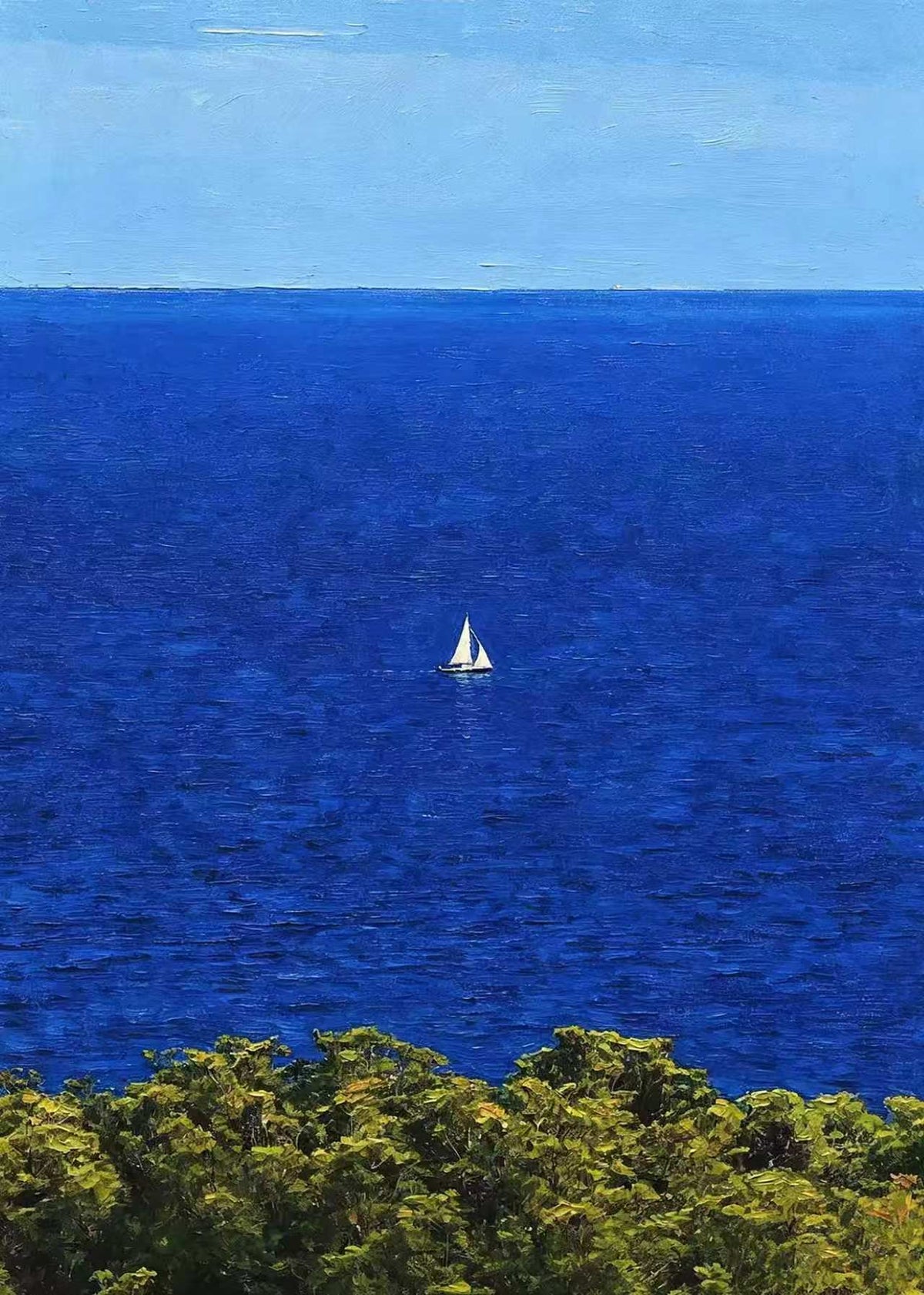 A single white sail on a vast cobalt sea above green treetops