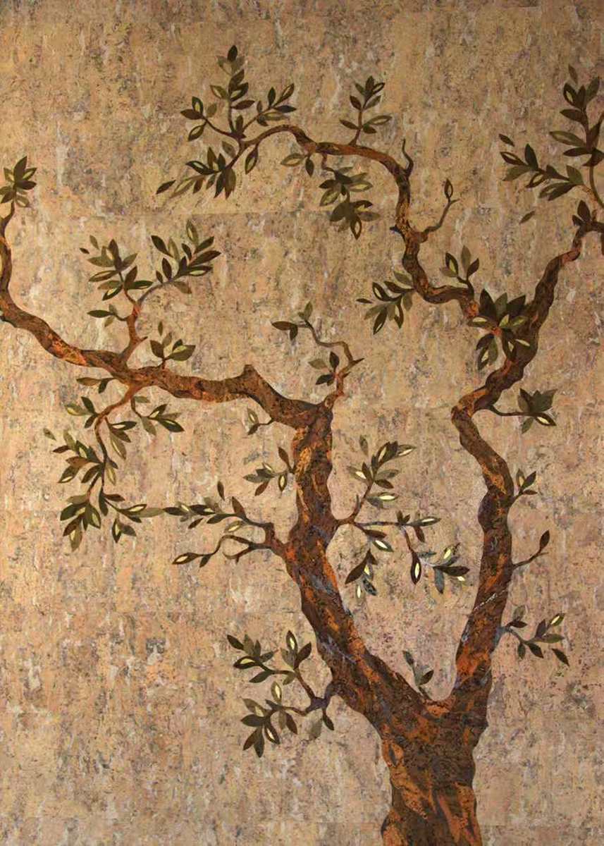 A gnarled olive tree with silvery leaves spreading across a warm, speckled stone-textured ground
