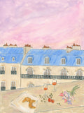 Blue mansard roofs under a pink sky, with croissants and wine on the table