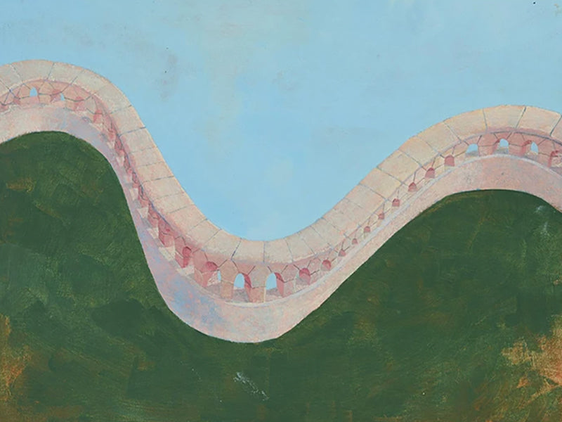 A curving pink wall winding across a green hill under blue sky