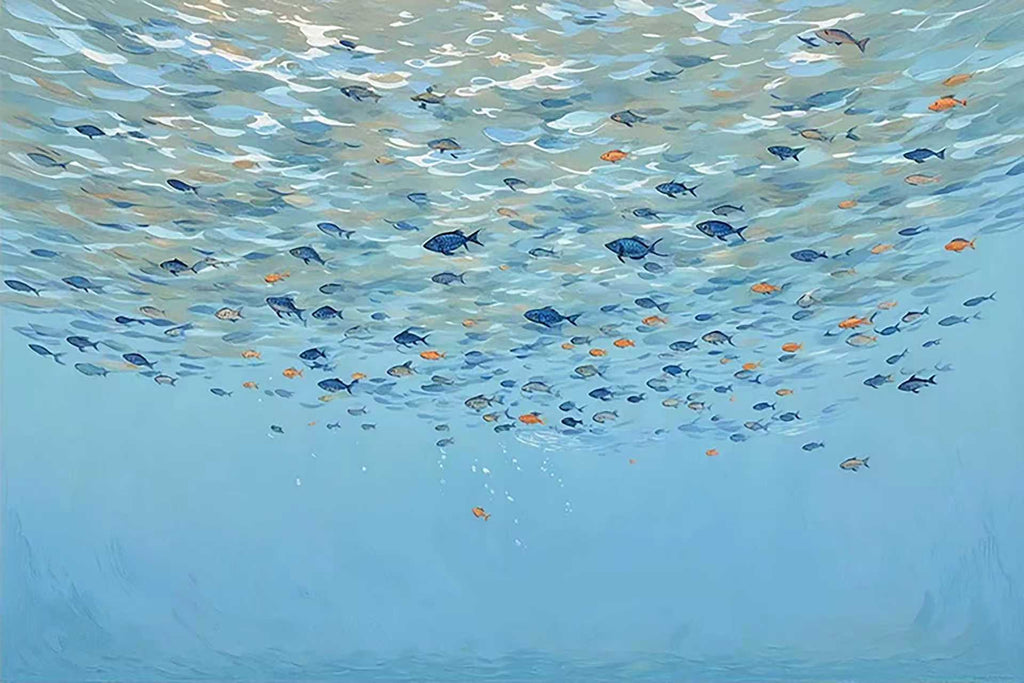 A shoal of tiny fish drifting through clear blue water