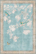 White blossoms and small birds on a pale blue panel with a soft border