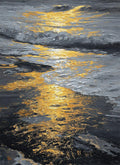 Molten gold light spilling across dark, silvery waves on a shoreline