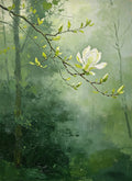 A single white magnolia bloom on a budding branch against a soft, misty green forest
