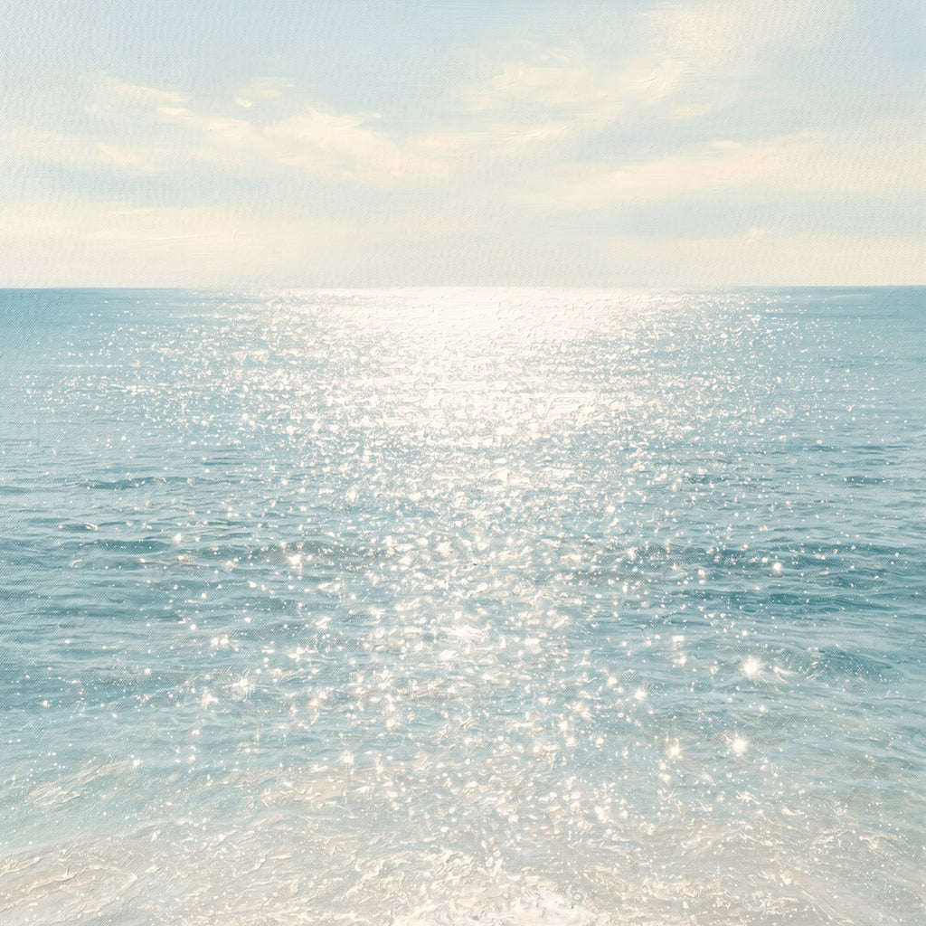 Sunlight sparkling across a calm turquoise sea under a pale sky