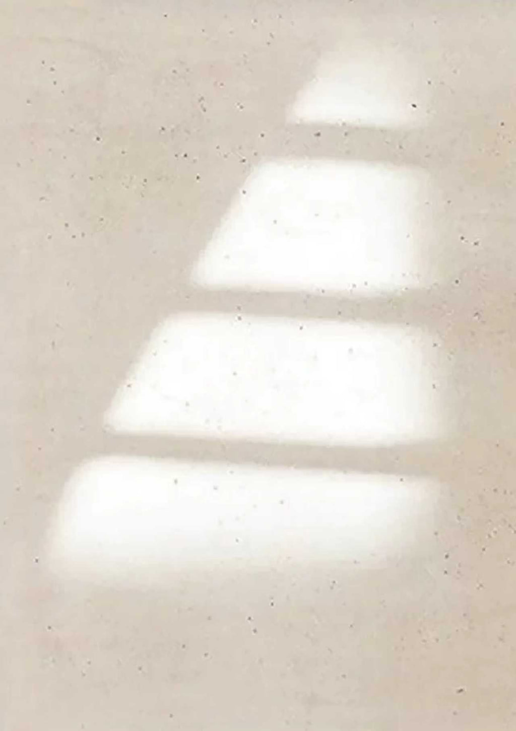 Soft bars of window light stepping across a pale speckled wall