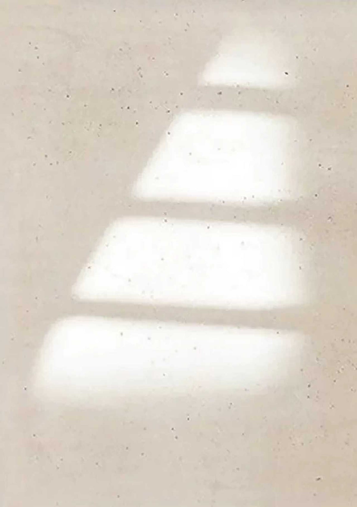 Soft bars of window light stepping across a pale speckled wall