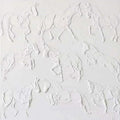 A herd of galloping horses sculpted in white plaster-like relief