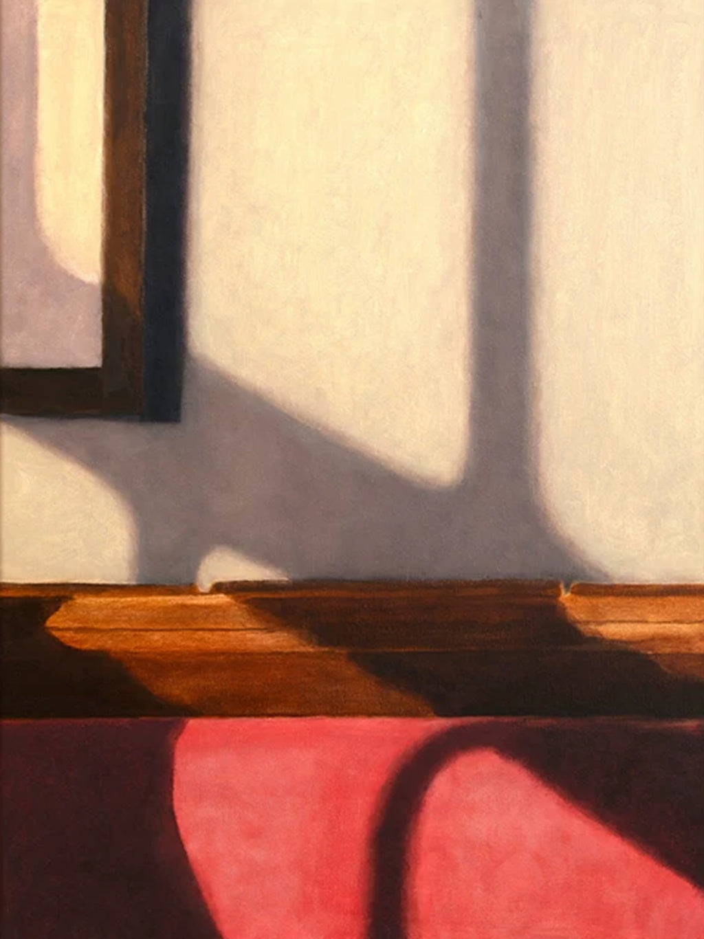 A window's shadow stretching across a pale wall above a wooden bench and a pink cushion
