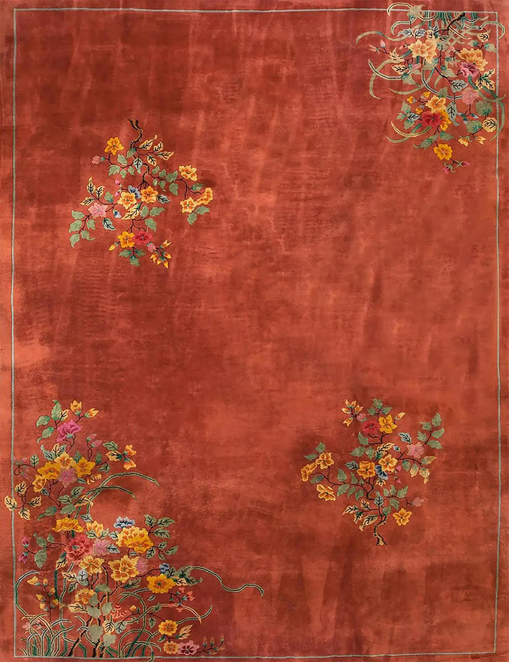 Small clusters of red and gold blossoms scattered over a rich terracotta field