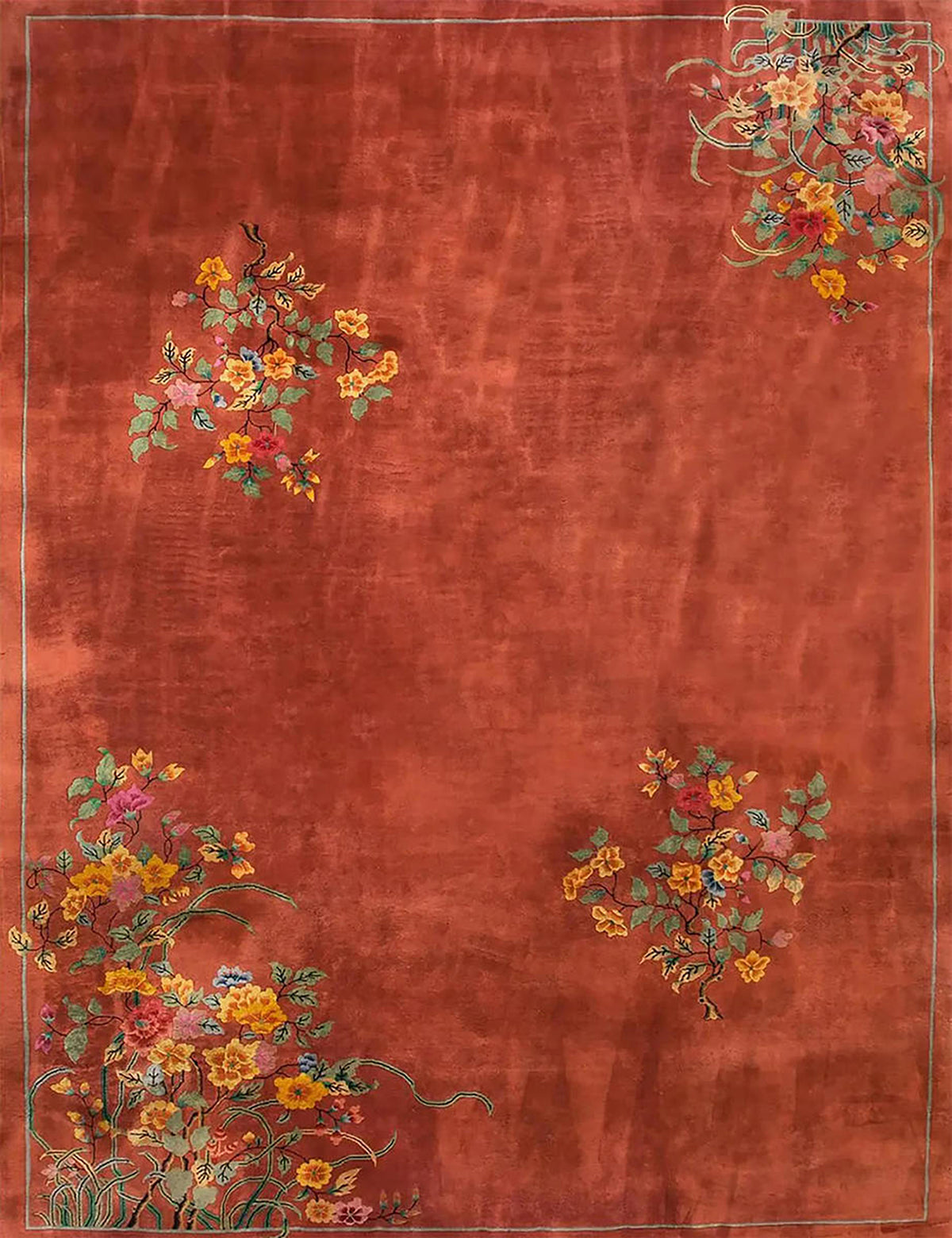 Small clusters of red and gold blossoms scattered over a rich terracotta field