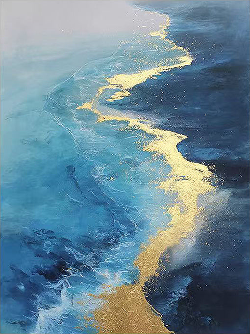 A ribbon of gold leaf tracing the line where turquoise surf meets a deep navy sea