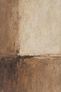 A block of textured cream resting on layered umber and rust, in a weathered abstract
