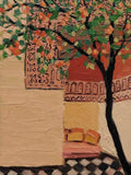 A dark-trunked tree with orange blossoms over a terracotta wall and checkered courtyard floor