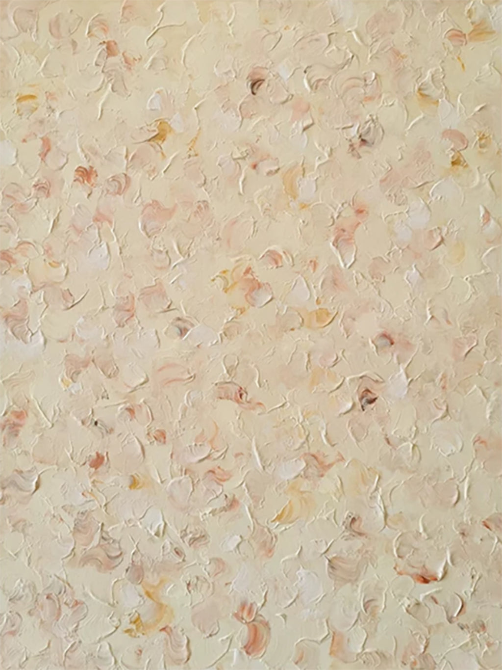 A field of tiny raised petals in cream, peach and gold scattered over a soft yellow ground
