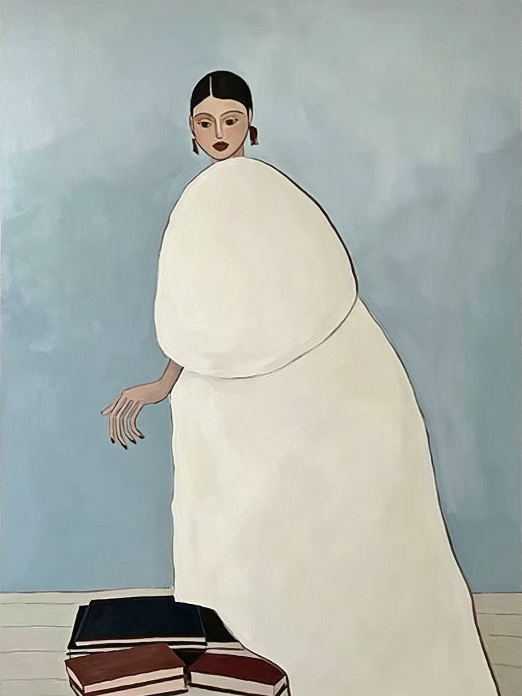 A woman in a voluminous white coat stepping off a stack of books against a pale blue wall