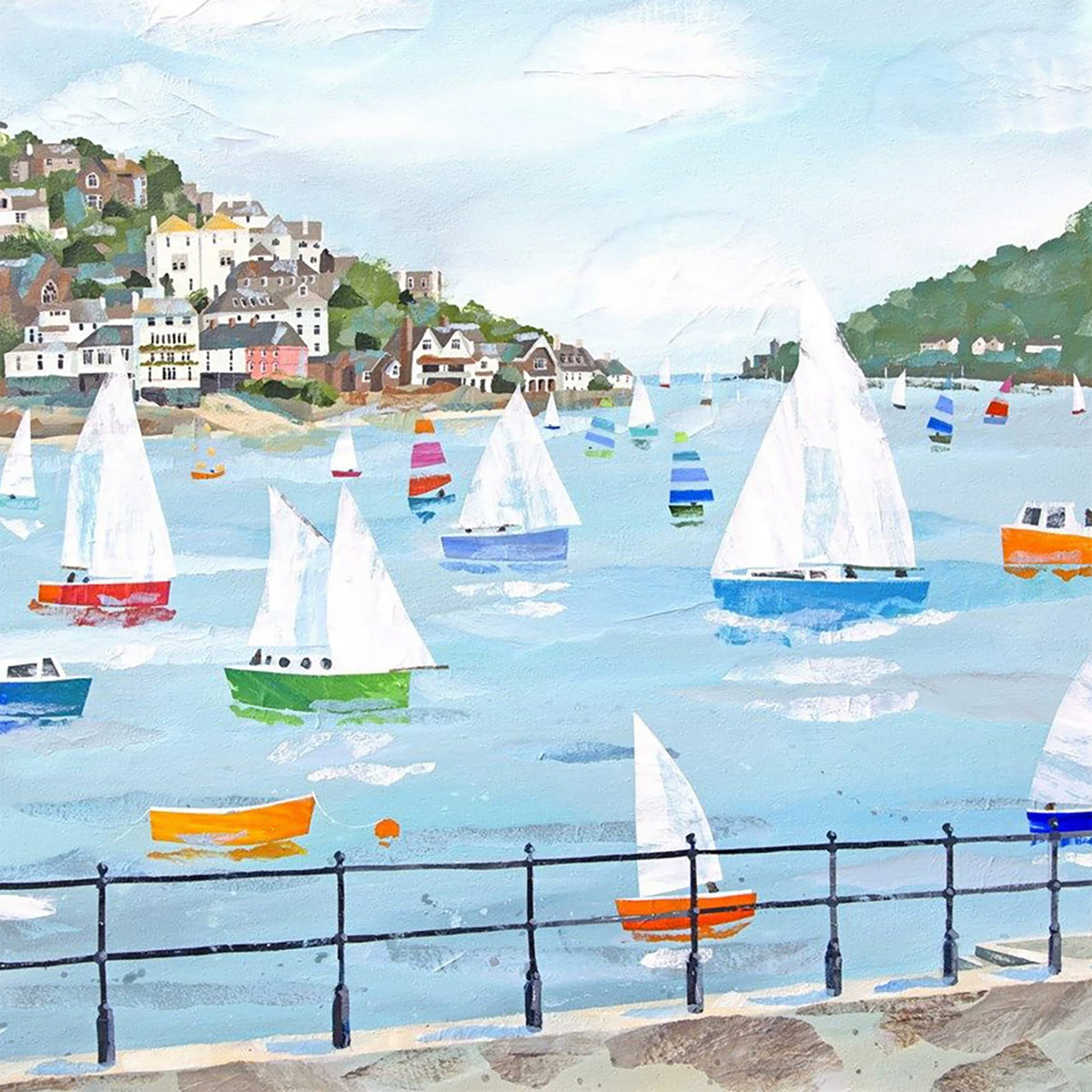 Colorful sailboats racing across a pale blue harbor below a hillside town