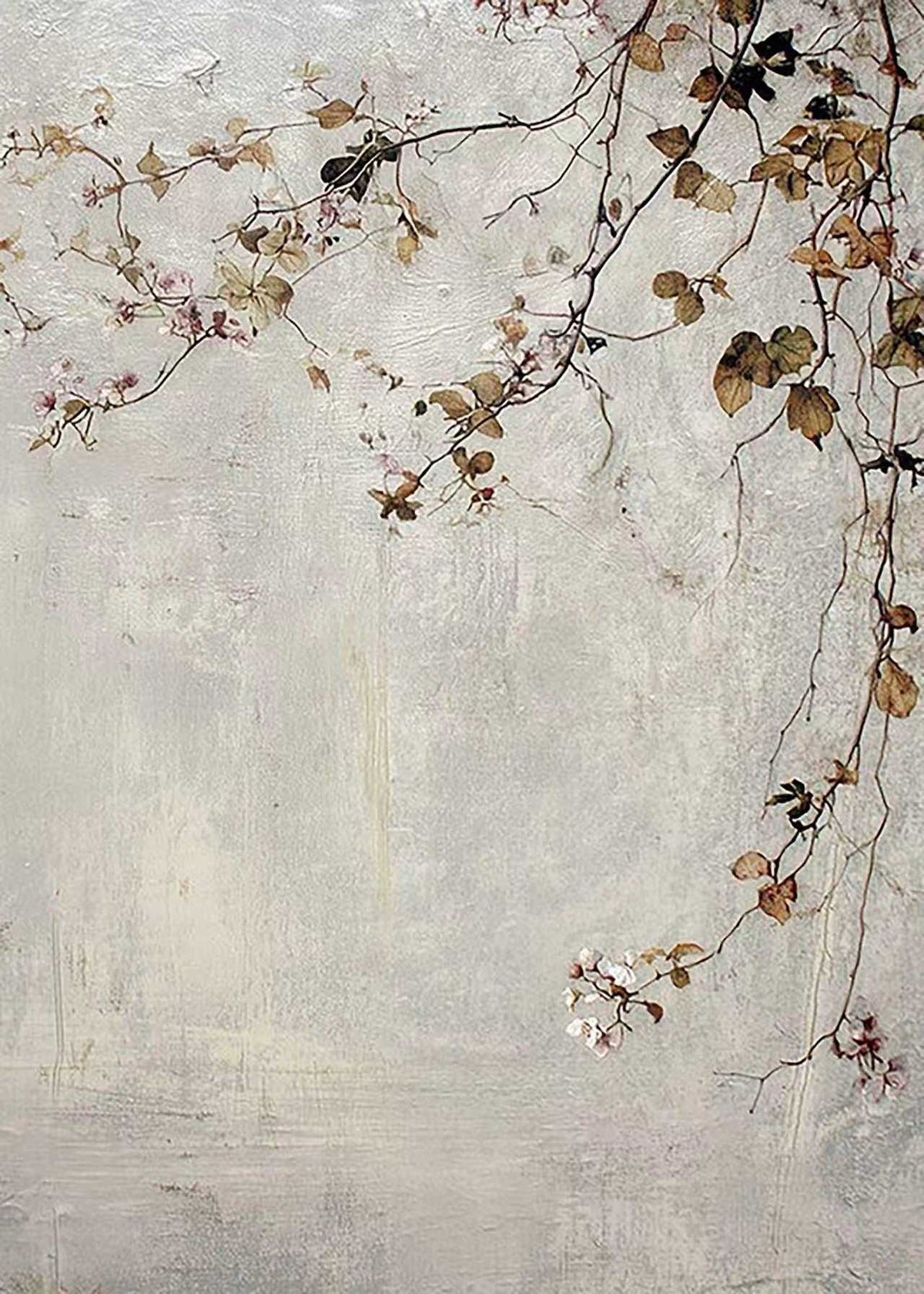 Thin branches with pale blossoms and russet leaves trailing over a weathered grey plaster wall