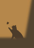 The silhouette of a cat reaching up for a butterfly on a warm amber wall
