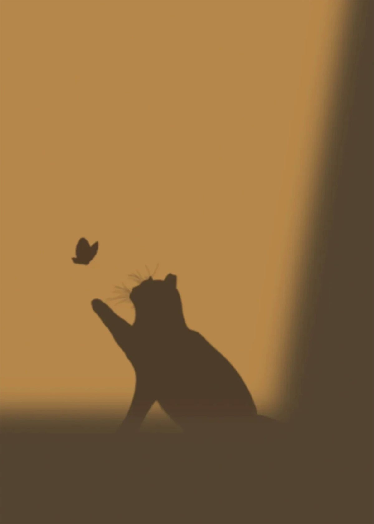 The silhouette of a cat reaching up for a butterfly on a warm amber wall