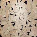 Overlapping cream leaf and crescent shapes in raised texture over a black ground