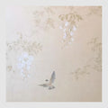 Pale wisteria and leaves drifting across a pearly champagne ground as a swallow swoops below