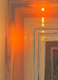 An orange sunset over the sea seen through receding frames of shimmering light