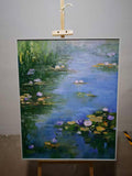 Water lilies floating on a green-blue pond in dappled light.