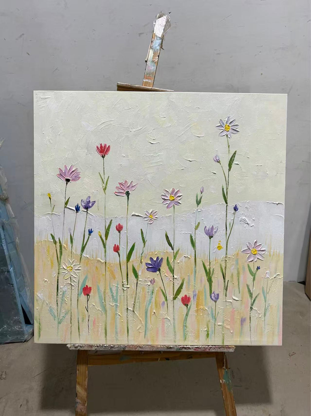 Colorful wildflowers scattered across a pale summer meadow.