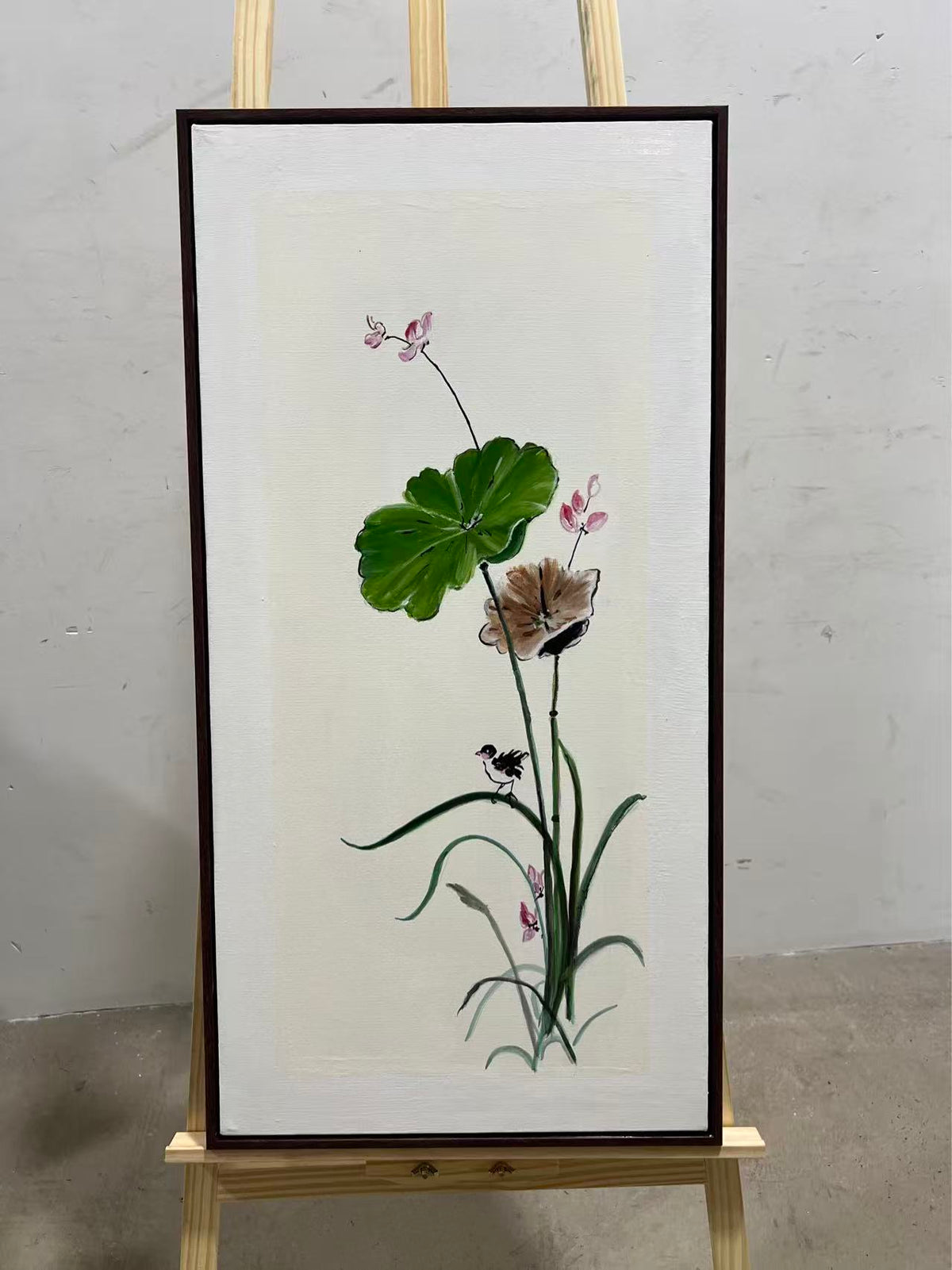 A single lotus stem with a green leaf and a blush bloom in ink style.