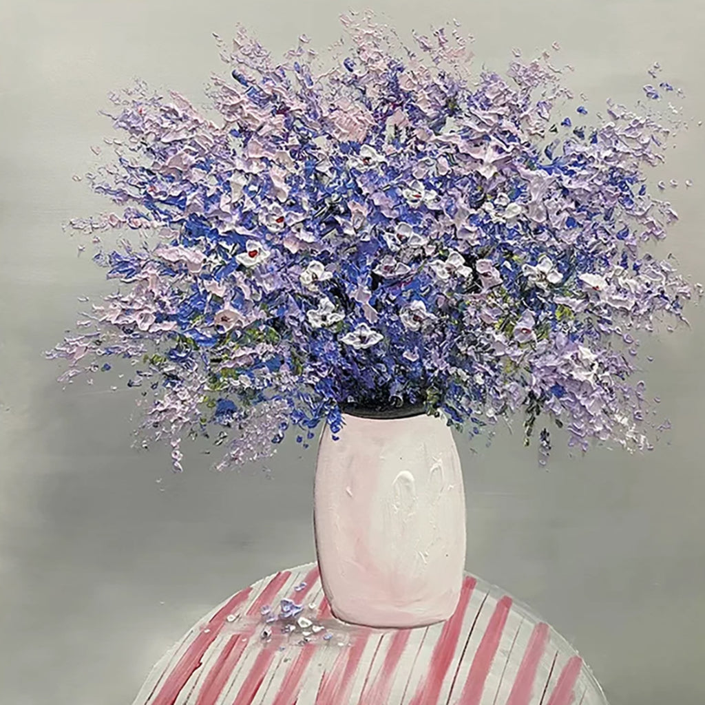 A cloud of violet blossoms in a pink vase on a red-and-white striped table