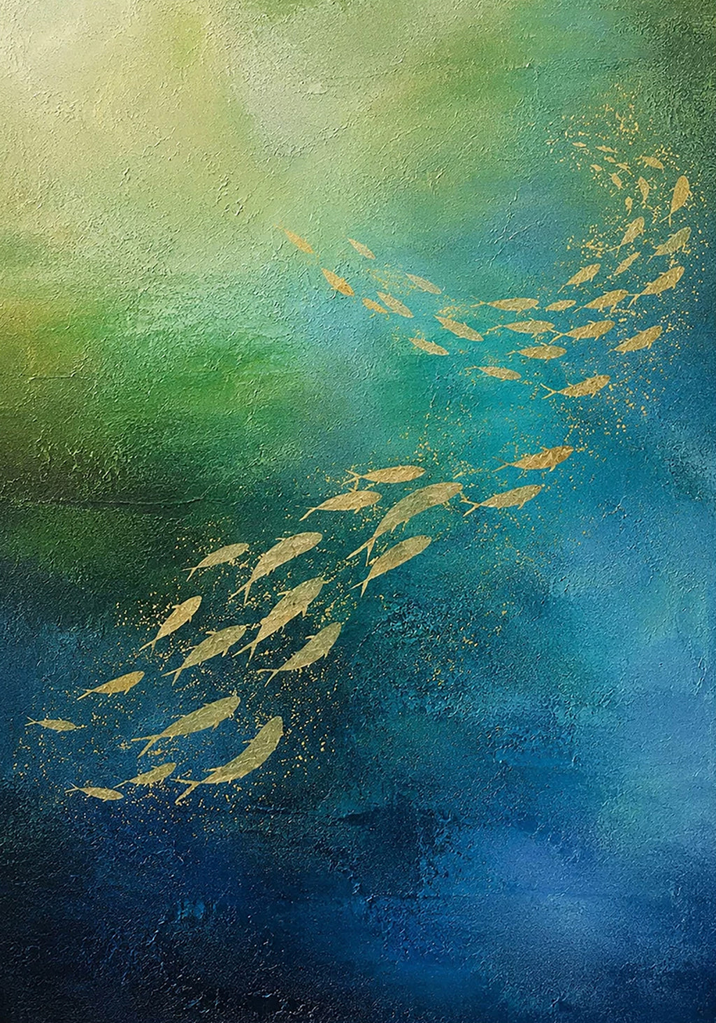 Golden fish drifting through deep teal water.