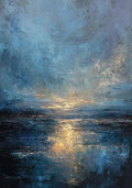 A low golden glow breaking through stormy blue clouds over a dark, glinting sea