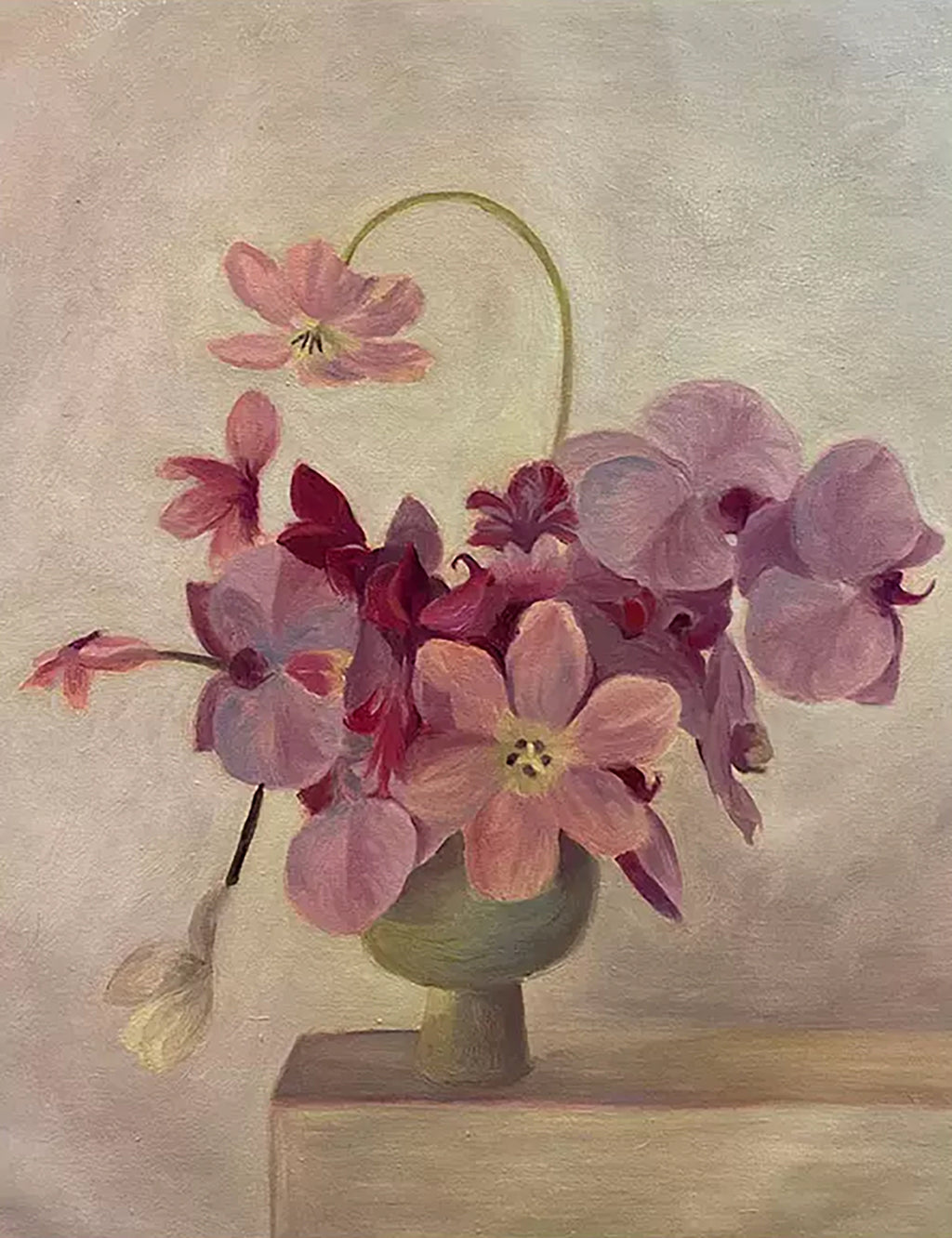 Pink and plum orchids spilling from a small green pot on a pale ledge