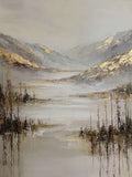 Misty hills touched with gold above a still silver lake fringed with reeds